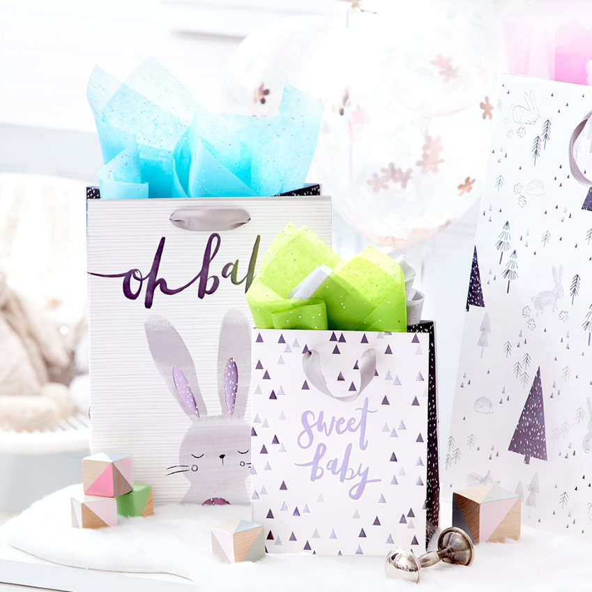 
Bunny and sweet baby gift bags surrounded by toys