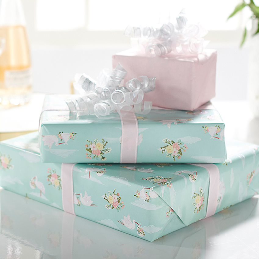 Stack of Gift Boxes Wrapped in White and Blue Floral Wrapping Paper
