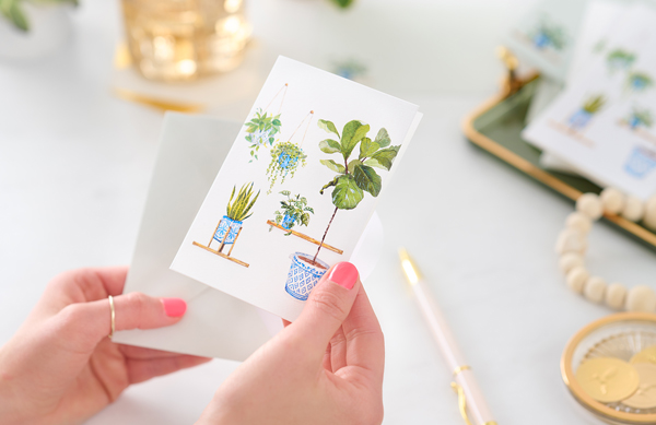 Woman holding plant stationery card