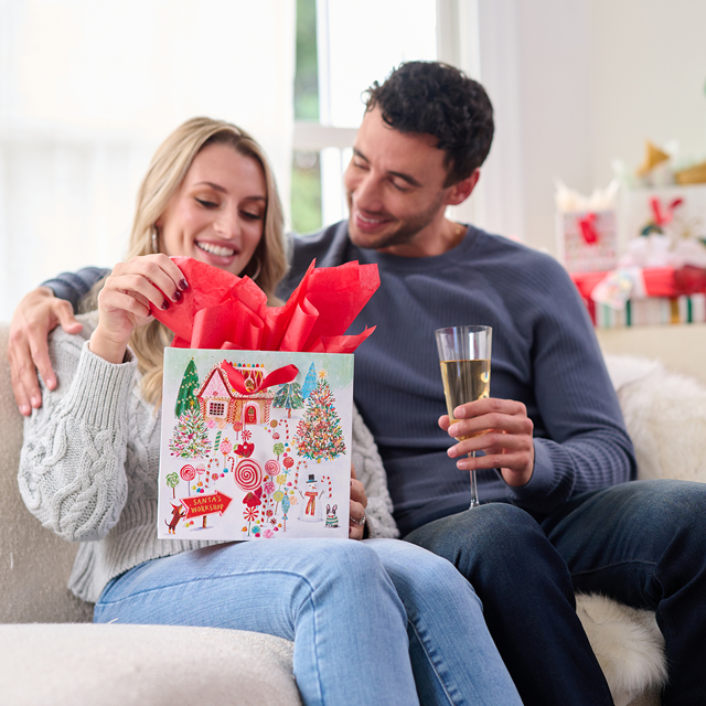 Couple unwrapping holiday gift