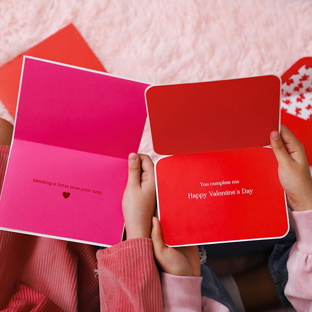 Girls holding reading Valentine's Day Cards