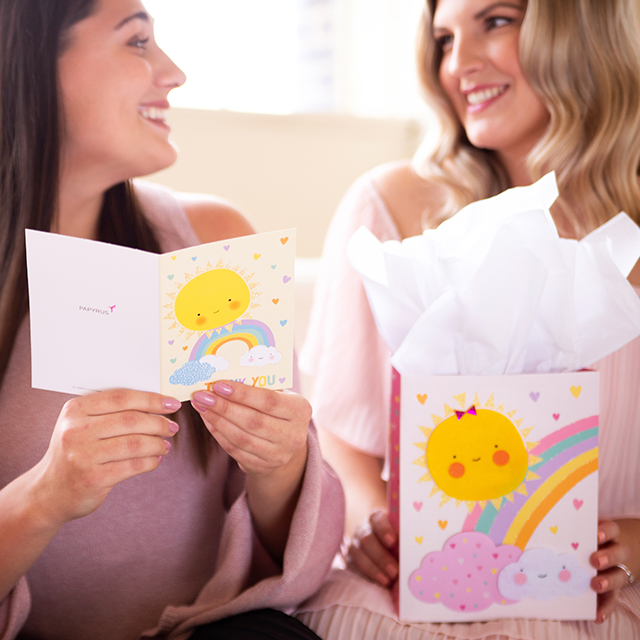 women at baby shower with card and gift
