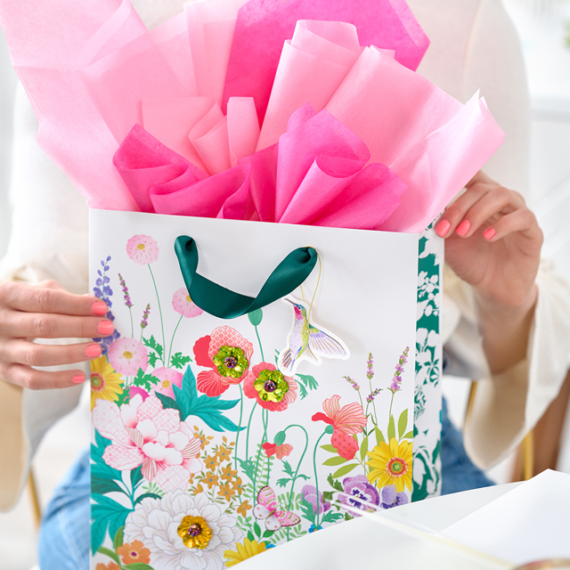 woman opening floral gift bag