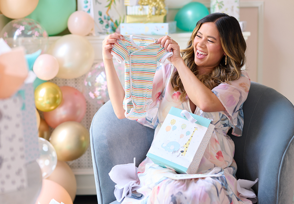 Expecting mother opening a present.