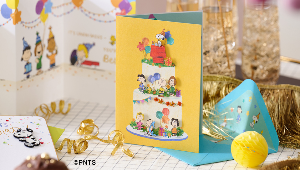 Peanuts themed cards on a birthday celebration table