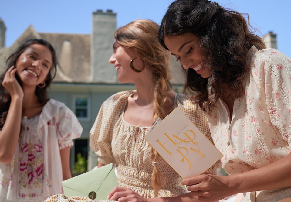 Women outside at a birthday gathering with a blue sky