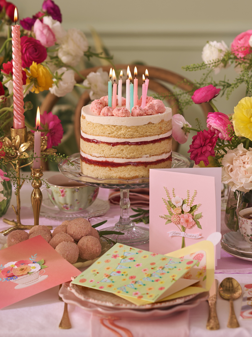 Traditional birthday candles on a cake.