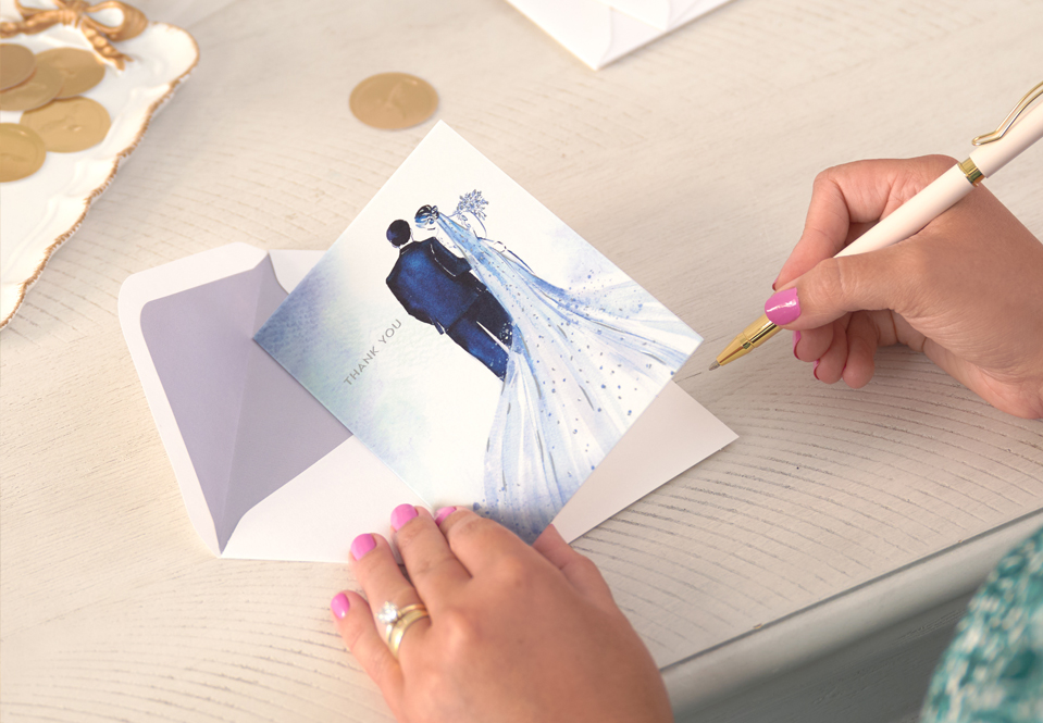 Female signing a wedding card at a table