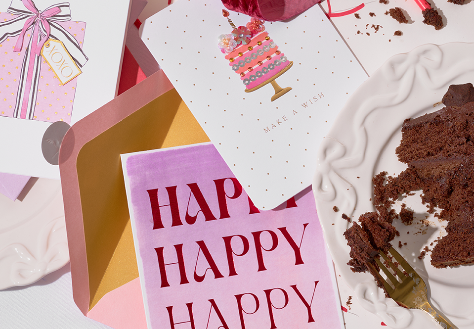 Birthday cards on a table with cake