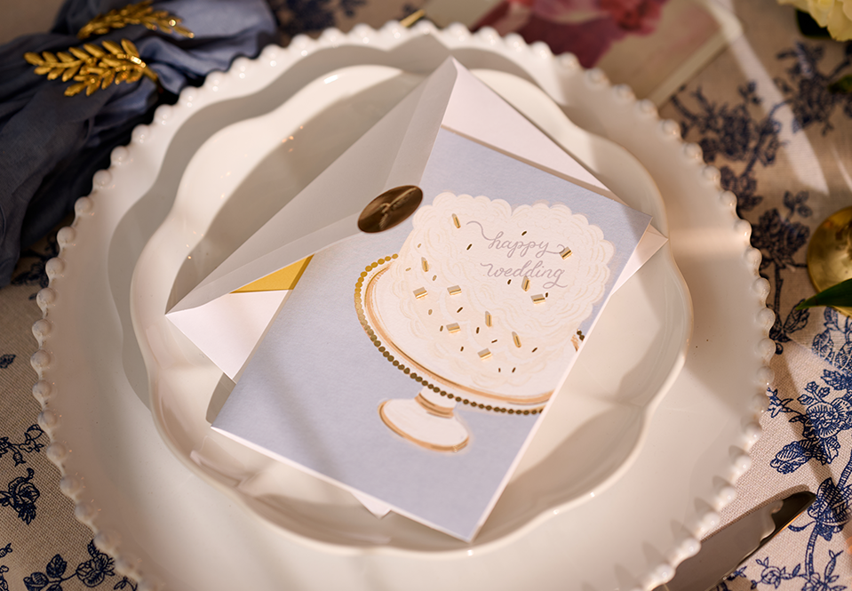 A wedding cake card on a plate