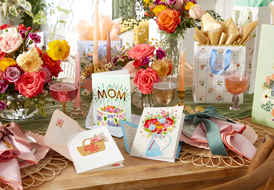 Mother’s Day cards and gift bags with flowers on a table
