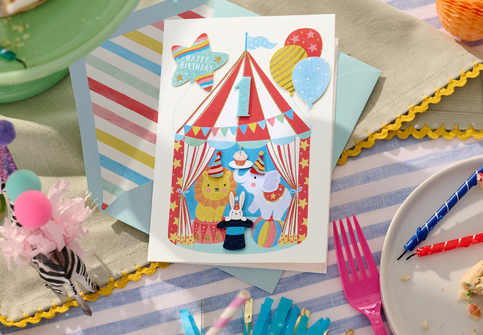 Circus birthday card on a table with favors and candles
