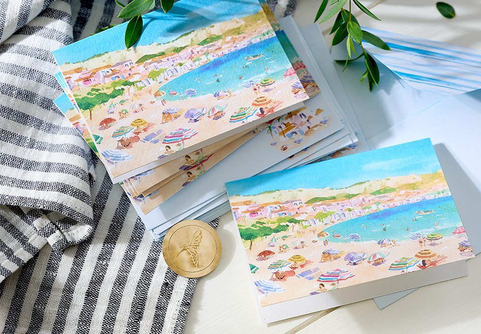 Beach themed stationery cards on a whitewashed table
