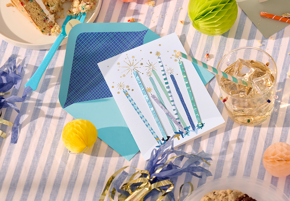Birthday card with blue candles on a table